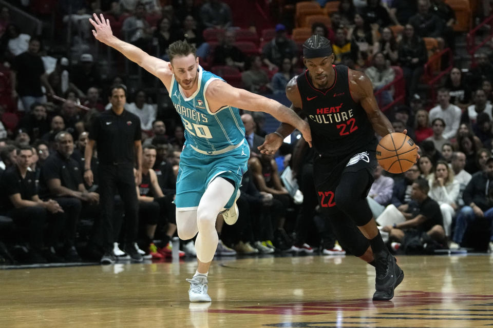 Miami Heat forward Jimmy Butler (22) steals the ball from Charlotte Hornets forward Gordon Hayward (20) during the first half of an NBA basketball game, Wednesday, Dec. 13, 2023, in Miami. (AP Photo/Lynne Sladky)