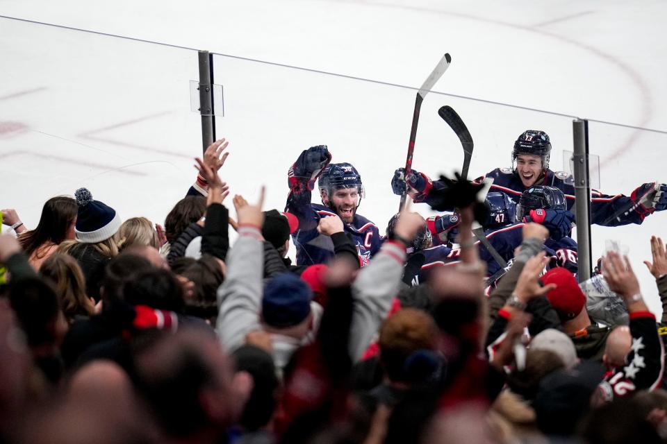 Nov 25, 2022; Columbus, Ohio, United States;  Columbus Blue Jackets forward Boone Jenner (38) and forward Johnny Gaudreau (13) celebrate with forward Kent Johnson (91) after he scored the Columbus Blue Jackets’s second goal during the second period of the NHL hockey game between the Columbus Blue Jackets and the New York Islanders at Nationwide Arena on Friday night. Mandatory Credit: Joseph Scheller-The Columbus Dispatch