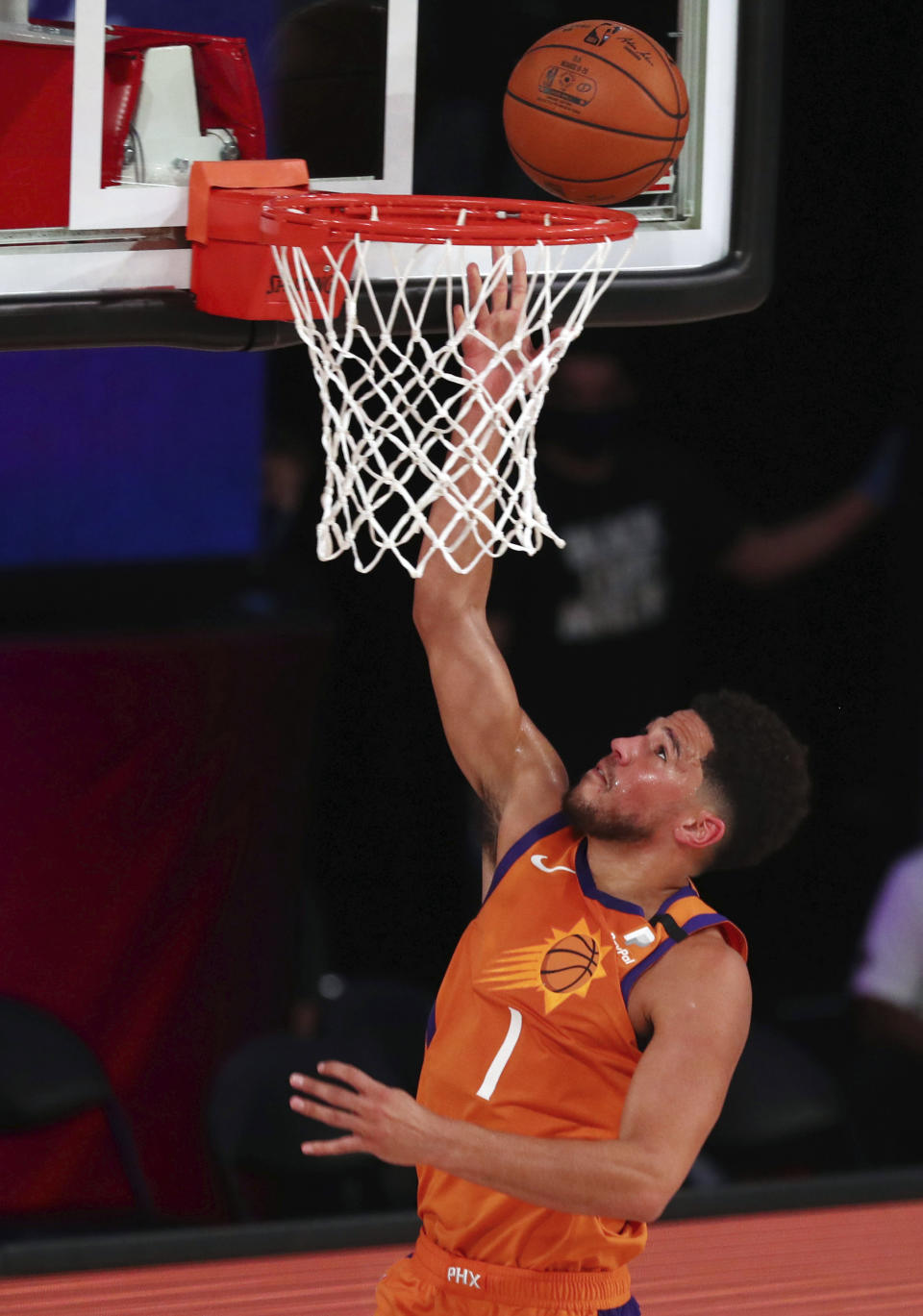 Phoenix Suns guard Devin Booker (1) shoots the ball against the Washington Wizards durin the first half of an NBA basketball game Friday, July 31, 2020, in Lake Buena Vista, Fla. (Kim Klement/Pool Photo via AP)