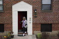 Catherine Busa leaves her apartment for a walk as part of her recovery from COVID-19 in New York, Wednesday, Jan. 13, 2021. The 54-year-old New York City school secretary didn’t have any underlying health problems when she caught the coronavirus in March and recovered at her Queens home. But some symptoms lingered. After eights months of suffering, she made her way to Jamaica Hospital Medical Center — to a clinic specifically for post-COVID-19 care. (AP Photo/Seth Wenig)