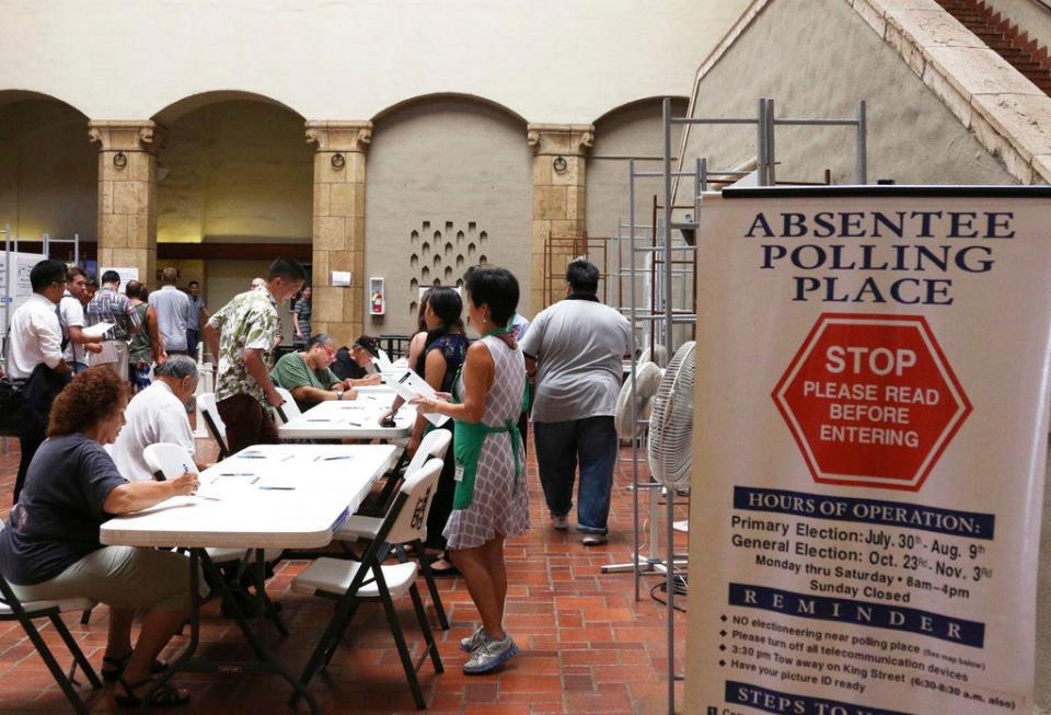 In this Thursday, Aug. 9, 2018, photo, voters sign in to vote at an early polling location in Honolulu. Hawaii's weekend primary election will most likely settle the outcome of this year's major races. (AP Photo/Jennifer Sinco Kelleher)