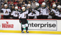 Arizona Coyotes right wing Dylan Guenther celebrates with teammates after scoring a goal against the New Jersey Devils during the first period of an NHL hockey game, Saturday, Nov. 12, 2022, in Newark, N.J. (AP Photo/Noah K. Murray)