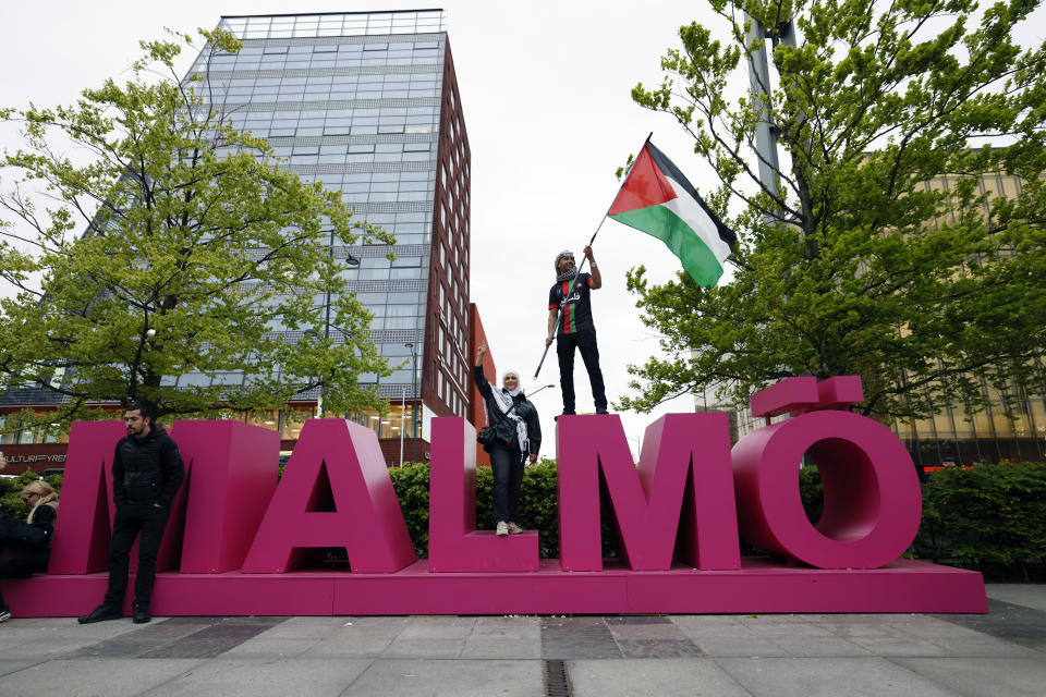 Pro-Palestinian protester waves a Palestinian flag at Hyllie arena ahead of the second semi-final of the 68th edition of the Eurovision Song Contest at Malmö Arena, in Malmö, Sweden, Thursday, May 09, 2024. (Andreas Hillergren/TT News Agency via AP)