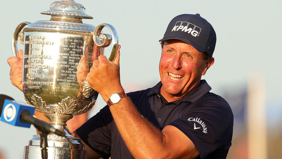 Pictured here, Phil Mickelson holds the US PGA Championship trophy aloft after winning the title in 2021.