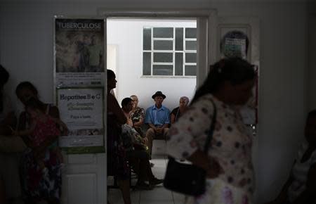 Patients wait to see Cuban doctor Eliza Barrios Calzadilla at the Health Center in the city of Itiuba in the state of Bahia, north-eastern Brazil, November 18, 2013. REUTERS/Ueslei Marcelino