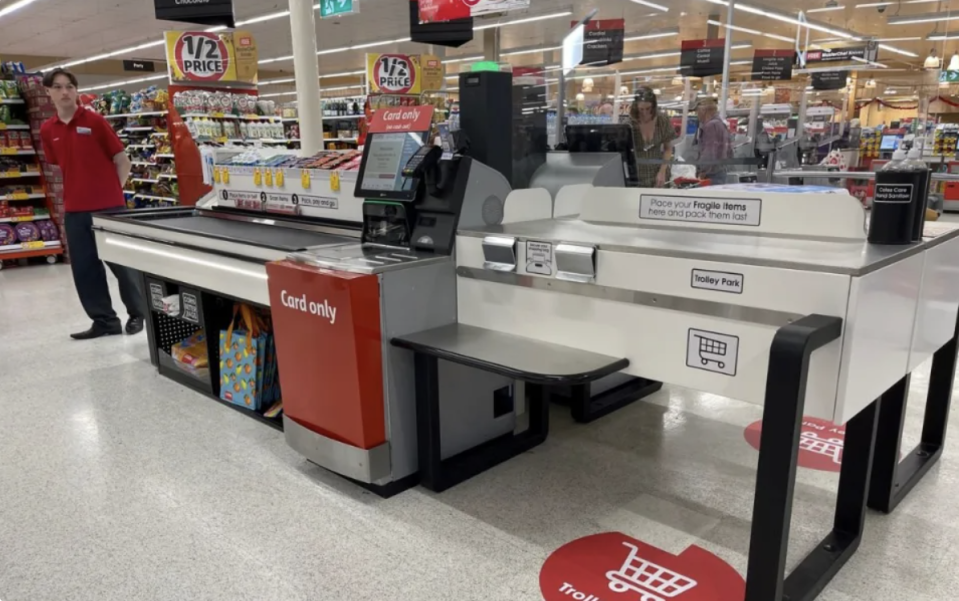 Coles self serve checkout with conveyor belt. 