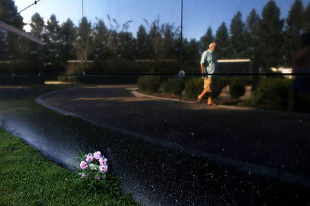 A man is reflected in the New Orleans Katrina Memorial in New Orleans, Louisiana, August 23, 2015. REUTERS/Jonathan Bachman