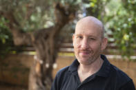 Israeli software developer Itamar Lev poses for a photograph at his house in the central Israeli city of Kfar Saba, Thursday, June 4, 2020. At first, when the coronavirus broke out, Lev was told to work from home. Then his salary was slashed 20%, his dining allowance was taken away and a long-term savings fund frozen. That's the harsh truth facing workers laid off around the world, from software companies in Israel to restaurants in Thailand and car factories in France, whose livelihoods fell victim to a virus-driven recession that's accelerating decline in struggling industries and upheaval across the global workforce. (AP Photo/Sebastian Scheiner)