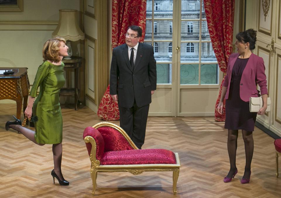 In this photo taken Tuesday, Feb. 19, 2013, French actors Daniel-Jean Colloredo, center, Marie Piton, left, and Dominique Merot perform in a scene of "Mr. Normal, His Women and Me," directed by Bernard Uzan, at the Tristan Bernard theater in Paris, France. A vow to keep his private life out of the public eye helped sweep Francois Hollande to power last year as France’s president, attracting voters tired of his flashy predecessor’s amorous exploits. Now, the words of the one-time dull Socialist are back to bite him in a new play. (AP Photo/Jacques Brinon)