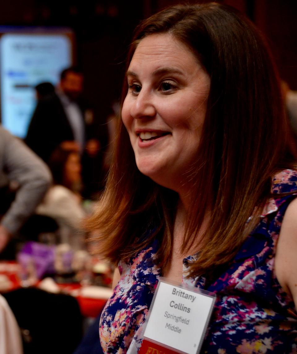 Springfield Middle School teacher Brittany Collins looks excitedly toward her colleagues shortly after being named the 2024-2025 WCPS Teacher of the Year on Wednesday night at the Fountain Head Country Club.