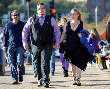 Eric Rogers, Winchester KY and his wife Bridget Rogers walk to Xcel Center as fans gather for an all-star concert paying tribute to memory of Prince, six months after the influential pop star died, in St. Paul, Minnesota, U.S., October 13, 2016. REUTERS/Craig Lassig