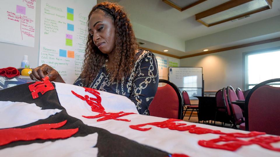 LaTonya Daniels works on a section for the AIDS Quilt at the Central Alabama Alliance Resource and Advocacy Center offices in Montgomery.