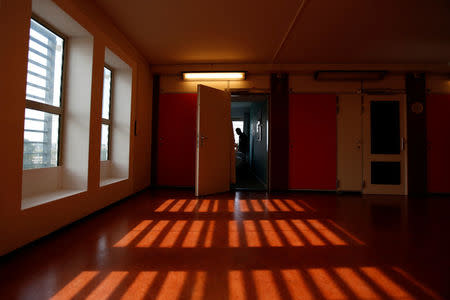 An unidentified asylum seeker stands inside the former Bijlmerbajes prison, transformed into both "The Movement Hotel", staffed and run by asylum-seekers, and a center for asylum-seekers, in Amsterdam, Netherlands, September 20, 2017. Picture taken on September 20, 2017. REUTERS/Cris Toala Olivares