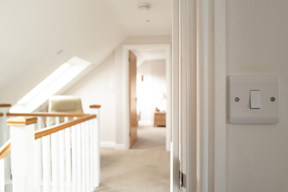 shallow focus of hallway through a bedroom door