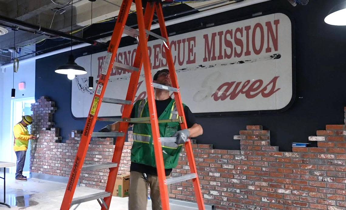The original Fresno Rescue Mission sign and bricks are incorporated into the design as workers continue construction at Fresno Mission’s new Heartbeat Hub Wednesday, Oct. 12, 2022 in Fresno.