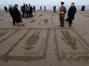 <p>The Pages of the Sea event also featured hundreds of full length figures drawn into the sand as a sobering reminder of the death toll of World War One. (PA) </p>
