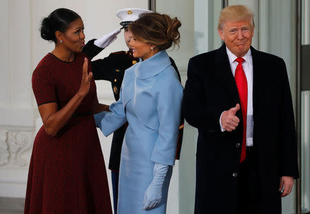 U.S. first lady Michelle Obama (L) greets U.S. President-elect Donald Trump (R) and his wife Melania for tea before the inauguration at the White House in Washington, U.S. January 20, 2017. REUTERS/Jonathan Ernst