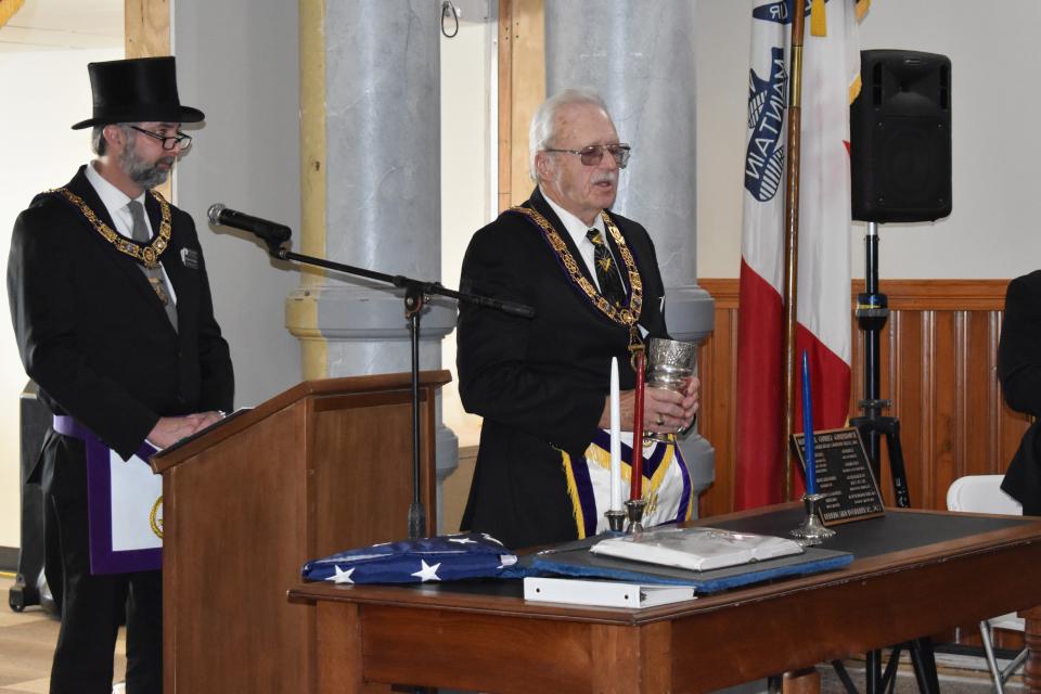 From left , Grand Master Theodore Wiley and Junior Grand Warden Drew Mathias of the Marshall County masonic lodge preside at the rededication ceremony for the county courthouse.