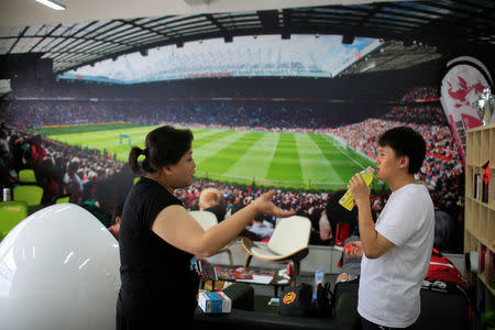 Fans of Manchester United Shanghai fan club chat at their club in Shanghai, China July 16, 2016. Picture taken July 16, 2016. REUTERS/Aly Song