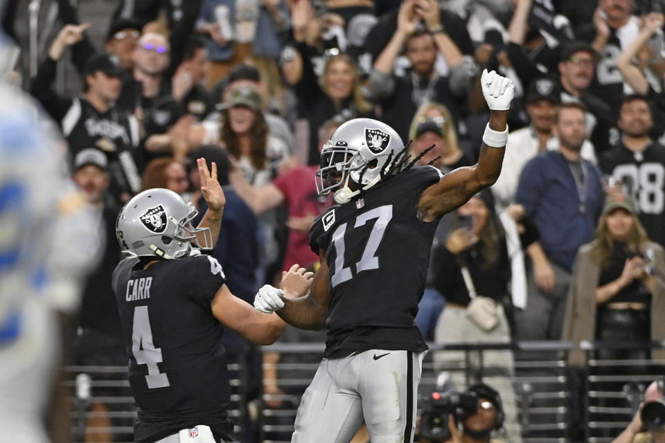 Las Vegas Raiders wide receiver Davante Adams (17) celebrates his touchdown reception with quarterback Derek Carr (4) during the second half of an NFL football game, Sunday, Dec. 4, 2022, in Las Vegas. (AP Photo/David Becker)