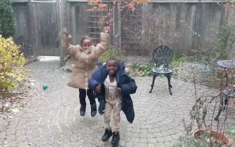 Two refugee children play in the snow for the first time in Toronto - Credit: Caters