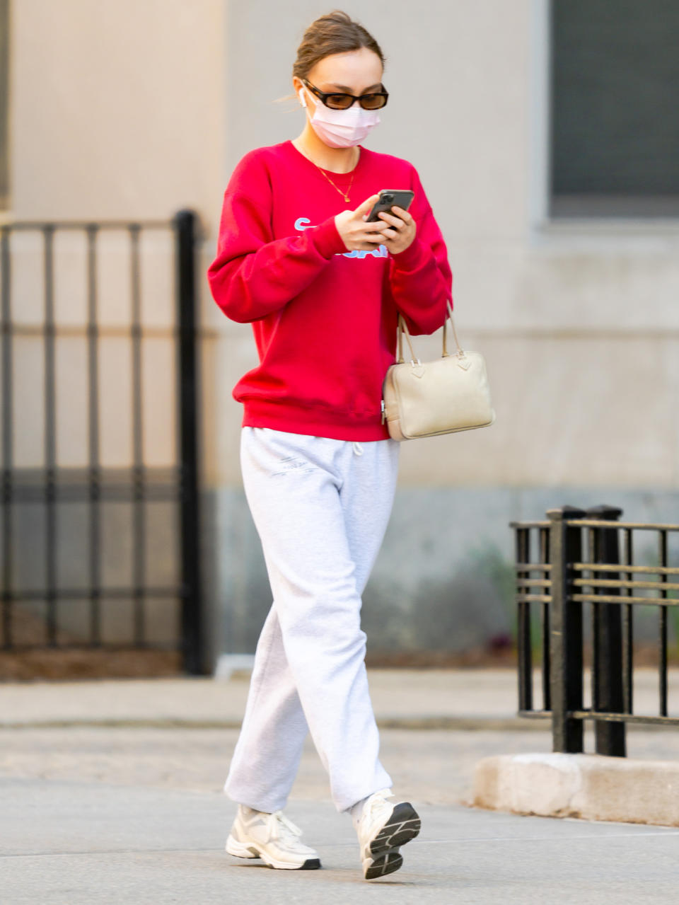 <p>Lily-Rose Depp checks her phone while out on a walk through N.Y.C. on Monday.</p>