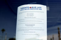 A sign announcing the suspension of spring training is displayed in the ticket window at TD Ballpark, Friday, March 13, 2020 in Dunedin, Fla. Major League Baseball has suspended the rest of its spring training game schedule because if the coronavirus outbreak. MLB is also delaying the start of its regular season by at least two weeks. (AP Photo/Carlos Osorio)