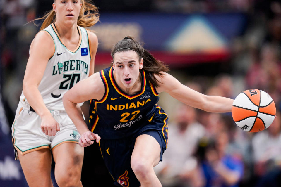 Indiana Fever guard Caitlin Clark (22) rushes up the court past New York Liberty guard Sabrina Ionescu (20) on Thursday. (Grace Hollars-USA TODAY Sports)