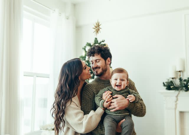 <p>Claire Lejeune/Shutterstock</p> Val Chmerkovskiy and Jenna Johnson celebrate their first Christmas with son Rome