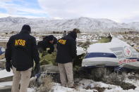 This photo provided by The National Transportation Safety Board shows NTSB investigators on Sunday, Feb. 26, 2023, at the crash site in Dayton, Nev., documenting the wreckage of a Pilatus PC-12 airplane a medical air transport flight operated by Guardian Flight that crashed on Friday, Feb. 24, while enroute from Reno, Nevada, to Salt Lake City. (NTSB via AP)