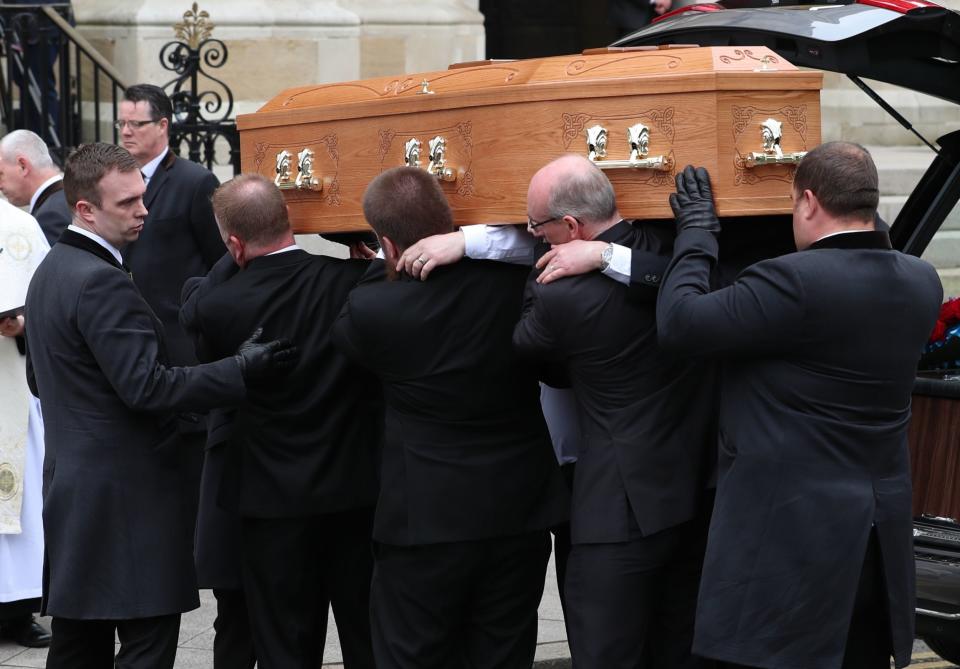The coffin is carried into the funeral service (PA)