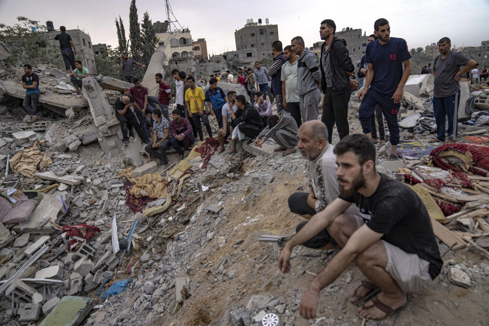 Palestinians look for survivors following an Israeli airstrike in Khan Younis, southern Gaza Strip, Sunday, Nov. 12, 2023. ( AP Photo/Fatima Shbair)