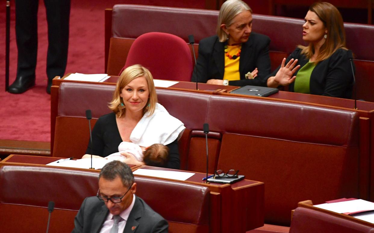 Australian Senator Larissa Waters breastfeeds her baby in the Senate Chamber at Parliament House in Canberra - REUTERS