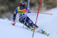 Greece's AJ Ginnis speeds down the course during the men's World Championship slalom, in Courchevel, France, Sunday Feb. 19, 2023. (AP Photo/Alessandro Trovati)
