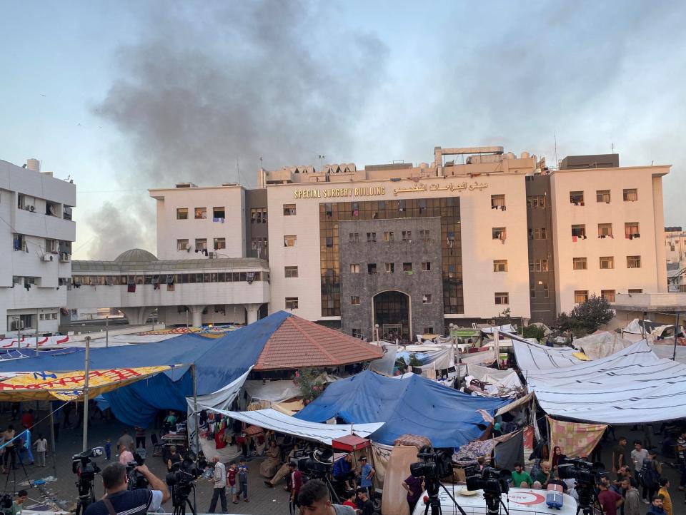 Smoke rises as displaced Palestinians take shelter at Al Shifa hospital (REUTERS)