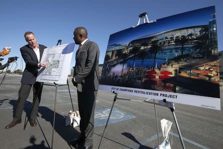 Hollywood Park Senior Vice President Chris Meany (L) and project manager Gerard McCallum display plans for development at the site of the former Hollywood Park Race Track at a news conference in Inglewood, Los Angeles, , January 5, 2015. REUTERS/Lucy Nicholson