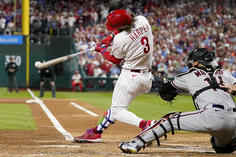 The Philadelphia Phillies' Bryce Harper hits an RBI single against the Arizona Diamondbacks during the third inning of Monday's Game 1 of the NLCS. (AP Photo/Brynn Anderson)