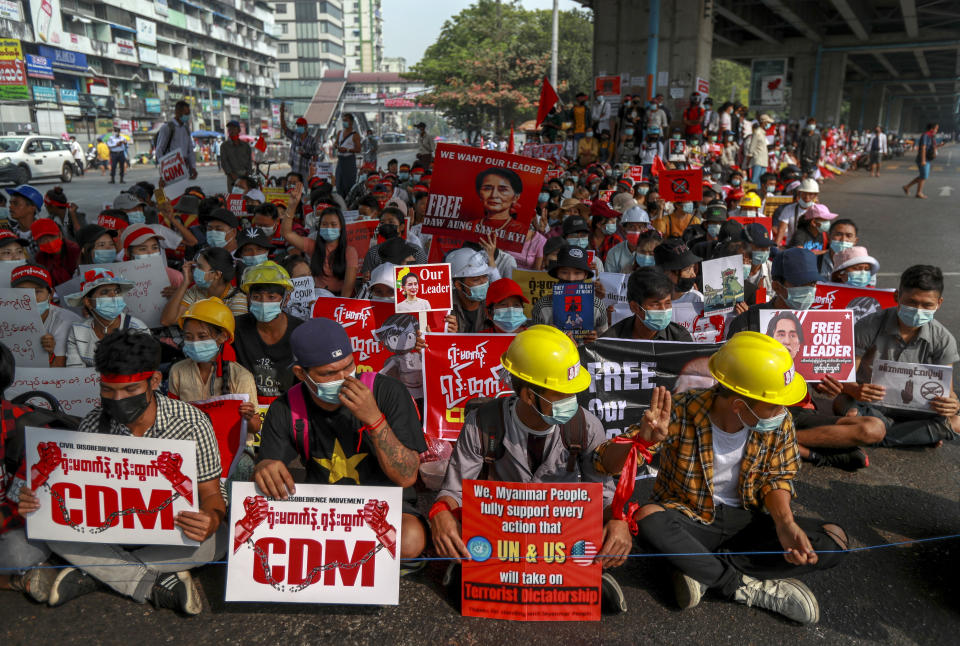 Demonstrators hold pictures of deposed Myanmar leader Aung San Suu Kyi during a protest against the military coup in Yangon, Myanmar Thursday, Feb. 18, 2021. Demonstrators against Myanmar’s military takeover returned to the streets Thursday after a night of armed intimidation by security forces in the country’s second biggest city.(AP Photo)