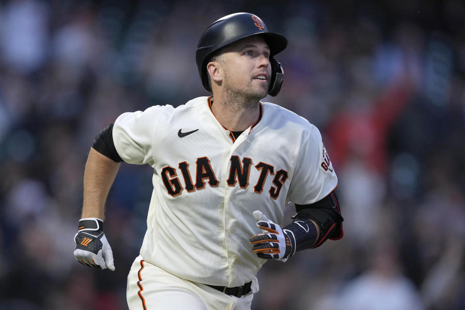 FILE - San Francisco Giants' Buster Posey watches his solo home run during the third inning of the team's baseball game against the Arizona Diamondbacks, Aug. 11, 2021, in San Francisco. Posey, the retired Giants catcher, has a year's worth of coursework remaining to complete his degree in social science at Florida State, yet he plans to spend the next two years finishing up given his busy home life with four children. (AP Photo/Tony Avelar, File)