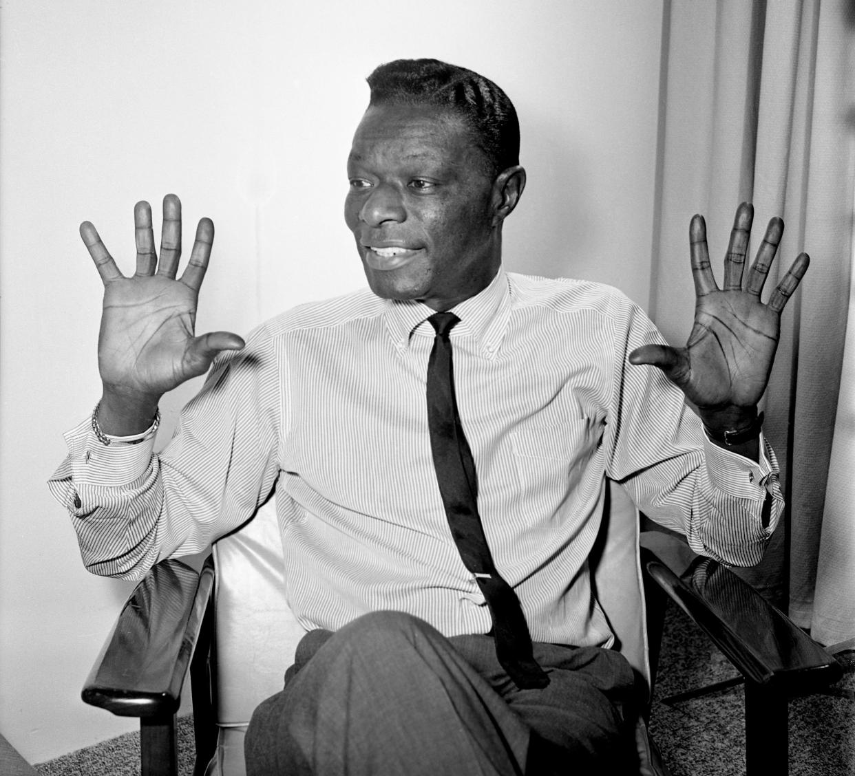 Nat King Cole answers some reporter’s question before his show in Nashville on Oct. 28, 1963. When asked why the change of style marked by the release of Ramblin’ Rose” last winter, the velvet-throated minstrel answers, “Music goes through cycles and country and western all of a sudden was popular.” “The King,” who doesn’t want to be typed as any one kind of singer, added “We try to go along with the pulse of what the public is buying.”