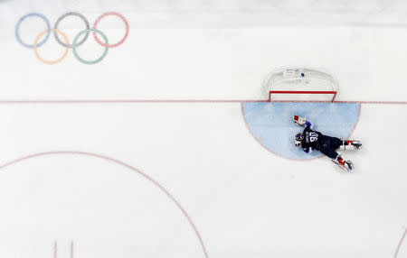 Ice Hockey - Pyeongchang 2018 Winter Olympics - Men's Playoff Match - U.S. v Slovakia - Gangneung Hockey Centre, Gangneung, South Korea - February 20, 2018 - Goalie Ryan Zapolski of the U.S. lies injured. REUTERS/Grigory Dukor