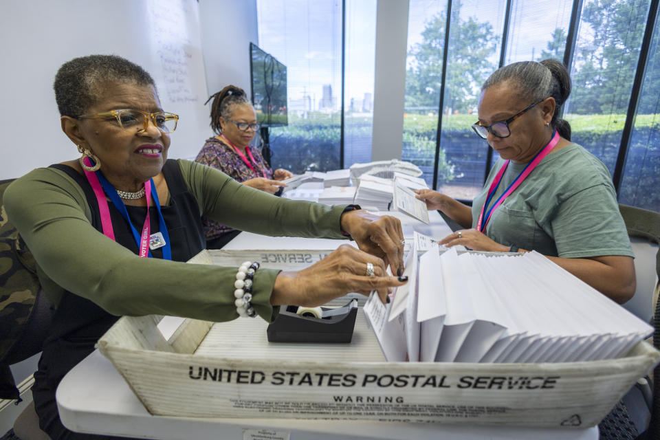 FILE - From left, Carol Hamilton, Cristo Carter and Cynthia Huntley prepare ballots to be mailed at the Mecklenburg County Board of Elections in Charlotte, N.C., Sept. 5, 2024. (AP Photo/Nell Redmond, File)