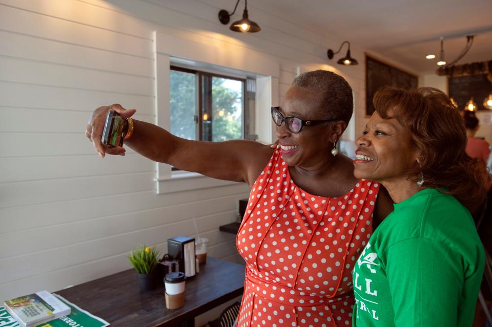Former Framingham Mayor Yvonne Spicer takes a selfie with Deborah Enos, of Ashland, at the Franklin St. Cafe on Franklin Street in Framingham, Aug. 12, 2022.