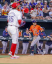 Houston Astros' Mauricio Dubón (14) rounds third base to score on a three-run home run by Victor Caratini during the fifth inning of a baseball game against the Texas Rangers, Monday, April 8, 2024, in Arlington, Texas. (AP Photo/Gareth Patterson)