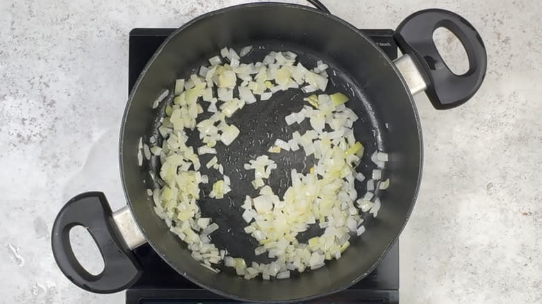 frying onion in pot