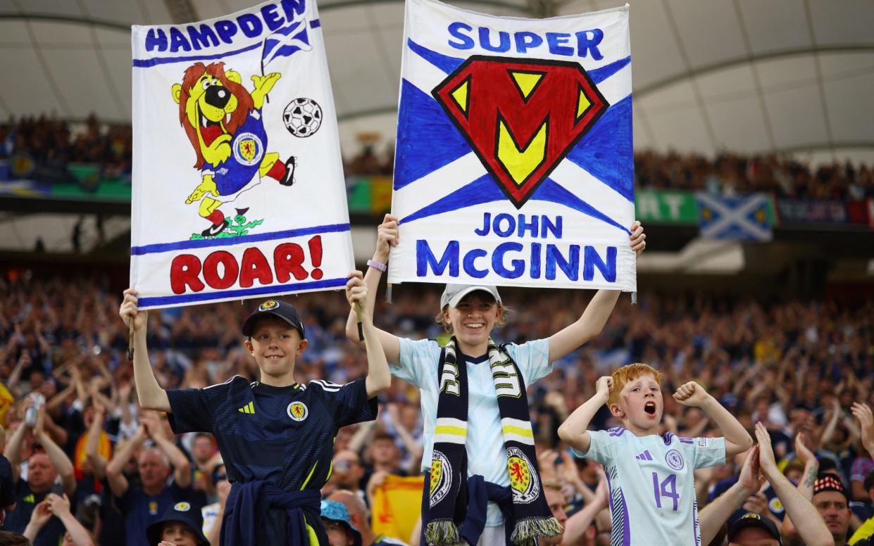 Scotland fan with a sign in support of John McGinn inside the stadium before the match
