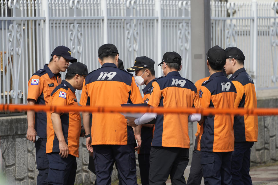 Firefighters work outside of the site of a burnt battery manufacturing factory in Hwaseong, South Korea, Tuesday, June 25, 2024. (AP Photo/Lee Jin-man)