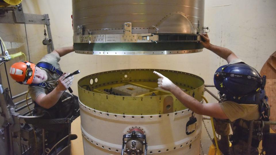 FILE - In this image provided by the U.S. Air Force, Airman 1st Class Jackson Ligon, left, and Senior Airman Jonathan Marinaccio, 341st Missile Maintenance Squadron technicians connect a re-entry system to a spacer on an intercontinental ballistic missile during a Simulated Electronic Launch-Minuteman test Sept. 22, 2020, at a launch facility near Malmstrom Air Force Base in Great Falls, Mont. (Senior Airman Daniel Brosam/U.S. Air Force via AP, File)