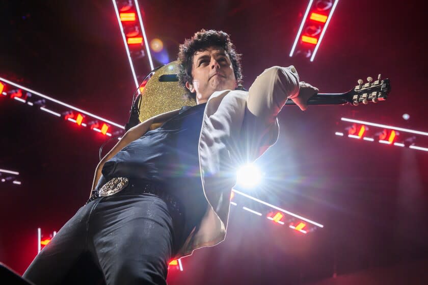 Billie Joe Armstrong playing guitar behind his back