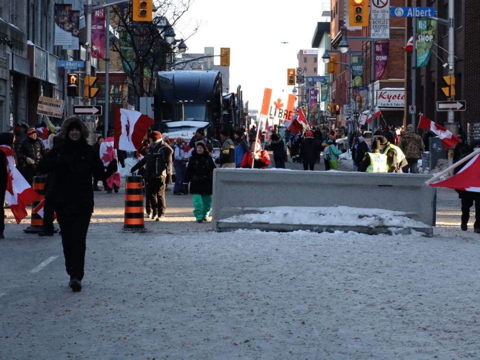 A view south on Bank Street in downtown Ottawa in early February shows road closures. Many businesses were hurt by the protest, but one that stayed open says it is now being evicted. (Michael Charles Cole/CBC - image credit)